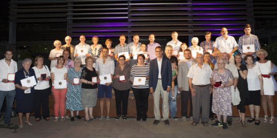 Foto de família dels guardonats amb la Medalla de la Vila a comerços castellarencs amb més de 50 anys d'història.